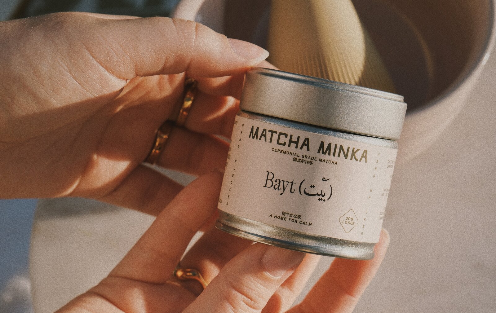 Hand holding Matcha Minka ceremonial matcha tin, 3-pack